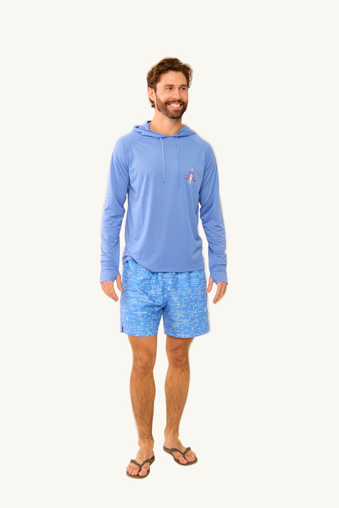 Man wearing a blue hoodie and shorts on a beige background